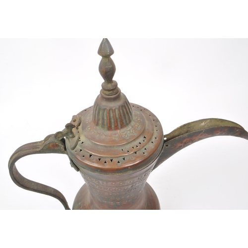 255 - A 19th century Turkish / Islamic dallah - coffee - pot. Fenial top with perforated lid, engraved dec... 