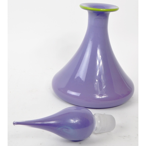 166 - A vintage 20th century purple glass wine decanter. Having a genie stopper with a green rim tapering ... 