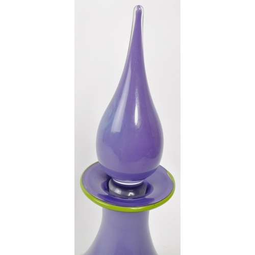 166 - A vintage 20th century purple glass wine decanter. Having a genie stopper with a green rim tapering ... 