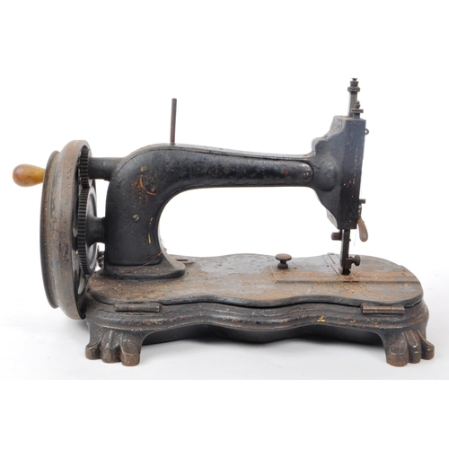 360 - A Victorian 19th century cast iron sewing machine. Turned wooden crank handle, ebonised body with ve... 