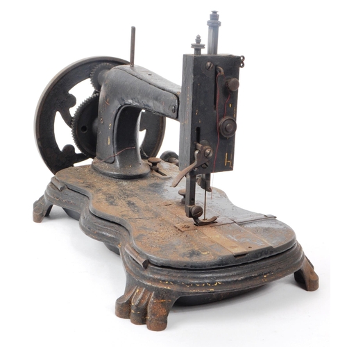 360 - A Victorian 19th century cast iron sewing machine. Turned wooden crank handle, ebonised body with ve... 