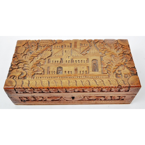 363 - An early 20th century carved Anglo Indian camphor wood jewellery box. With elephant, foliate and arc... 