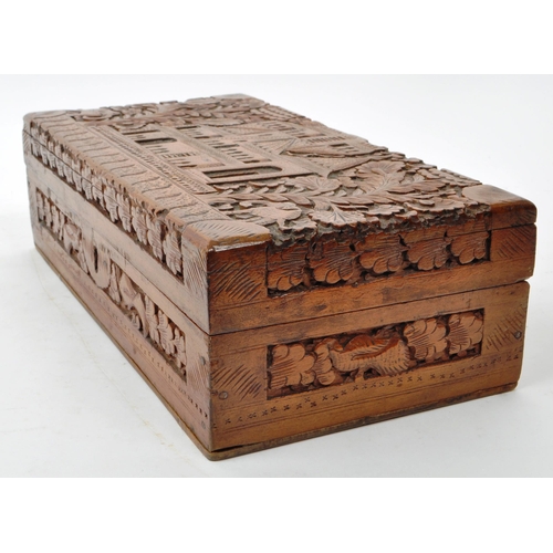 363 - An early 20th century carved Anglo Indian camphor wood jewellery box. With elephant, foliate and arc... 