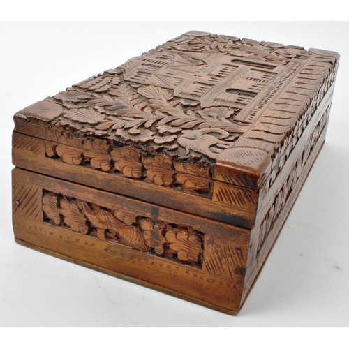 363 - An early 20th century carved Anglo Indian camphor wood jewellery box. With elephant, foliate and arc... 