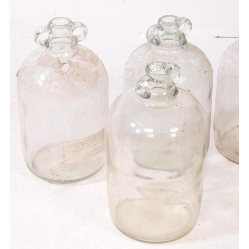 128 - A collection of six vintage 1980s Demijohn glass brewing bottles. Some with labels dating 'September... 