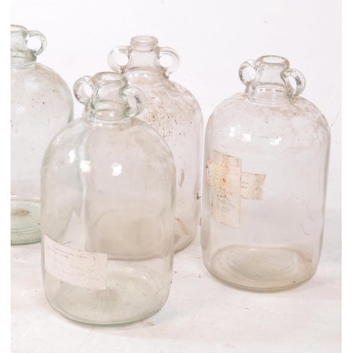 128 - A collection of six vintage 1980s Demijohn glass brewing bottles. Some with labels dating 'September... 