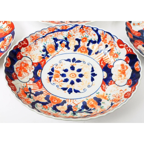 155 - A collection of late 19th century Imari style patterend dish plates and large serving platter. Featu... 