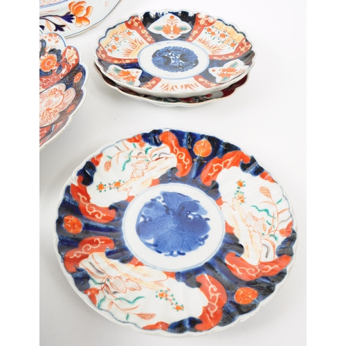 155 - A collection of late 19th century Imari style patterend dish plates and large serving platter. Featu... 