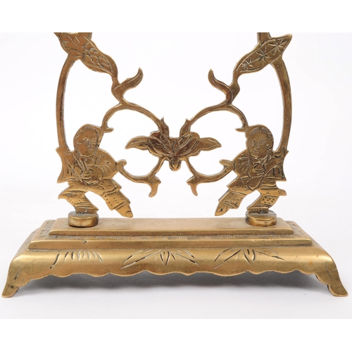 349 - An early 20th century 1920s Chinese stamped brass candelabra. The candelabra featuring three candle ... 