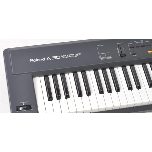 424 - Roland - A 1993 A-30 midi keyboard controller, serial no. AG82565. Manual, power cable, and sheet mu... 