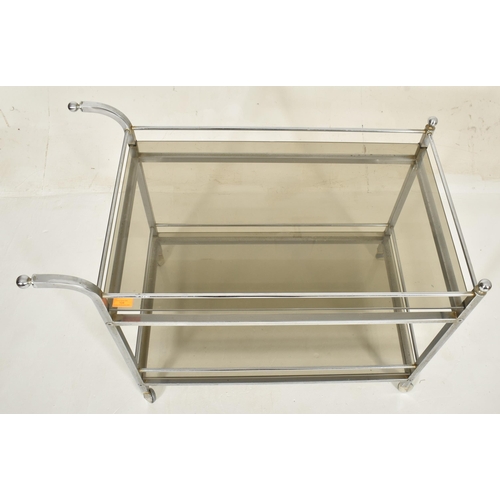 104 - 


A retro mid century high end Italian smoked glass and chrome drinks trolley. The tea trolley with... 