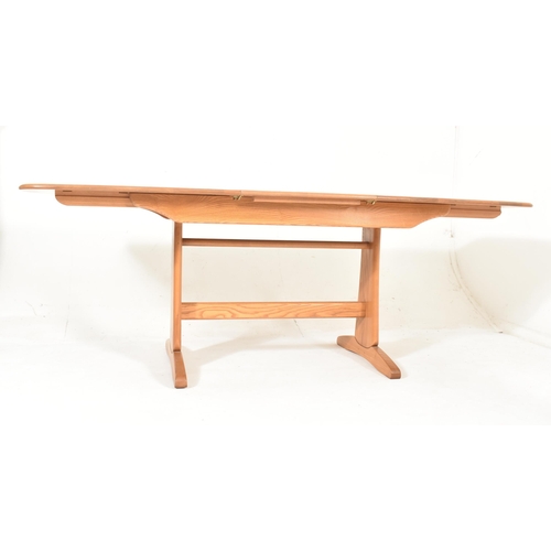 116 - Ercol Furniture - Windsor Rage - a beech & elm extending dining table. The table hving a curved ... 