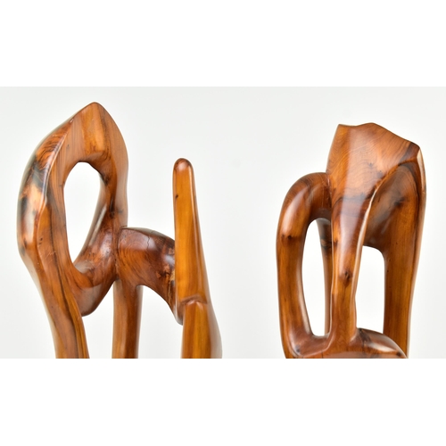 119 - A pair of contemporary carved and polished elm wood abstract carvings. Each of free worked form rais... 