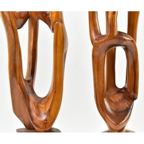 119 - A pair of contemporary carved and polished elm wood abstract carvings. Each of free worked form rais... 