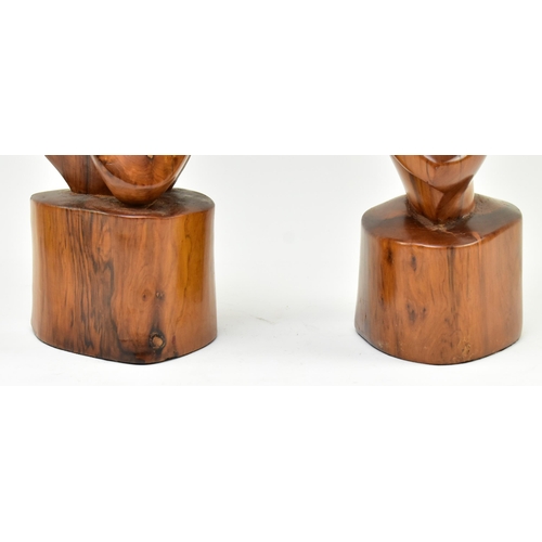 119 - A pair of contemporary carved and polished elm wood abstract carvings. Each of free worked form rais... 