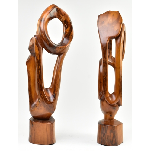 119 - A pair of contemporary carved and polished elm wood abstract carvings. Each of free worked form rais... 