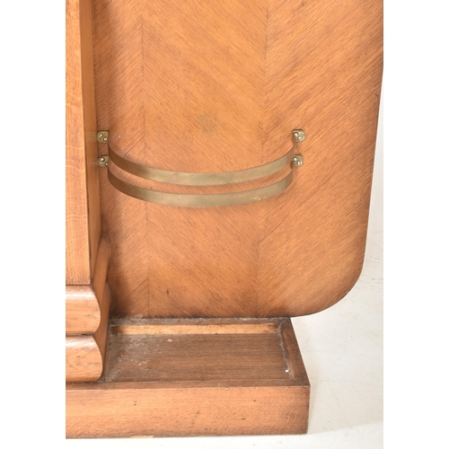 12 - A 20th century Art Deco walnut veneered hall stand. The stand of slender form, having coat and hat h... 