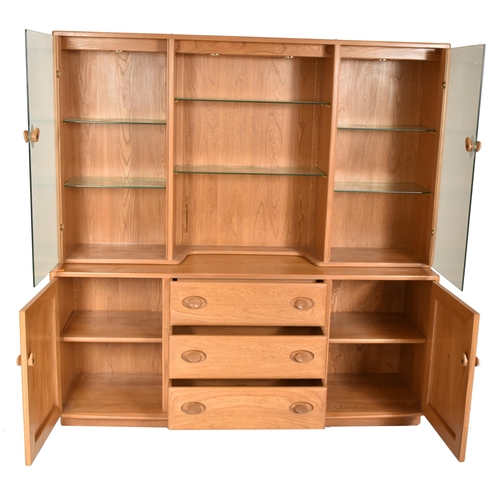 129 - Ercol - Windsor Range - a beech & elm glazed display unit cabinet. The cabinet having a central ... 