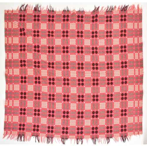 134 - A vintage 20th century hand woollen traditional Welsh blanket. The blanket in hues of hot pink, blue... 