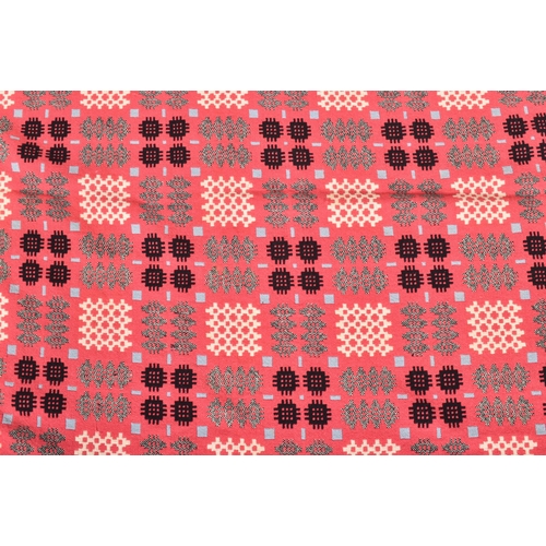 134 - A vintage 20th century hand woollen traditional Welsh blanket. The blanket in hues of hot pink, blue... 