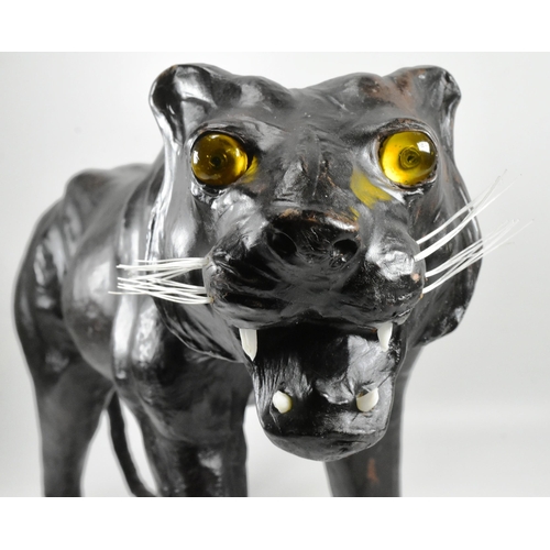 142 - An early to mid 20th century vintage leather covered model of a panther / big cat, in the manner of ... 