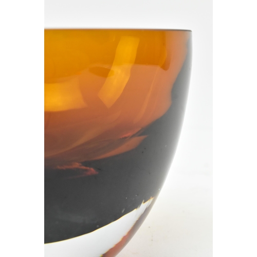 156 - A 20th century hand blown studio art glass bowl. The bowl of circular form in an amber colourway. Un... 