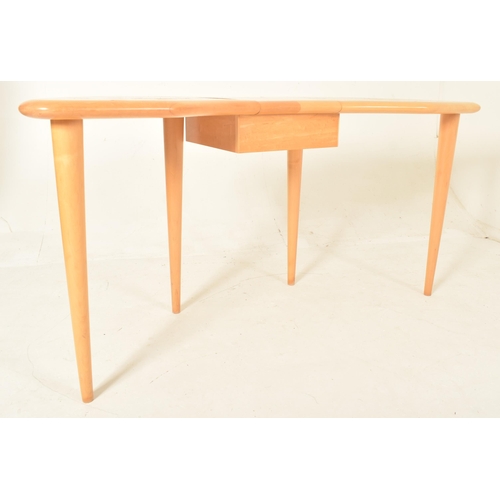 16 - A contemporary designer maple wood dressing table desk. The table having a kidney-shaped top with a ... 