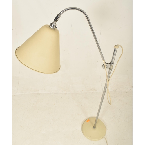 166 - A contemporary Stilnovo manner floor standing lamp light. The lamp having a large cream conical shad... 