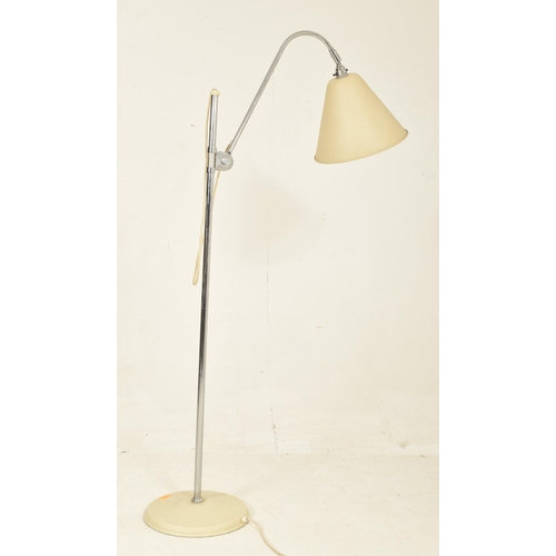 166 - A contemporary Stilnovo manner floor standing lamp light. The lamp having a large cream conical shad... 