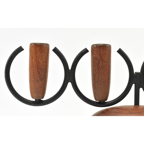 175 - A retro 20th century Danish design candlestick holder. The candlestick having three turned teak hold... 