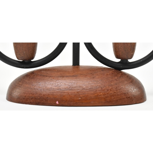 175 - A retro 20th century Danish design candlestick holder. The candlestick having three turned teak hold... 