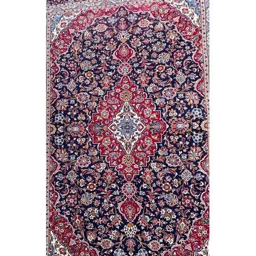 203 - A large 20th century Persian Islamic Tabriz floor carpet rug. The carpet having a central medallion ... 