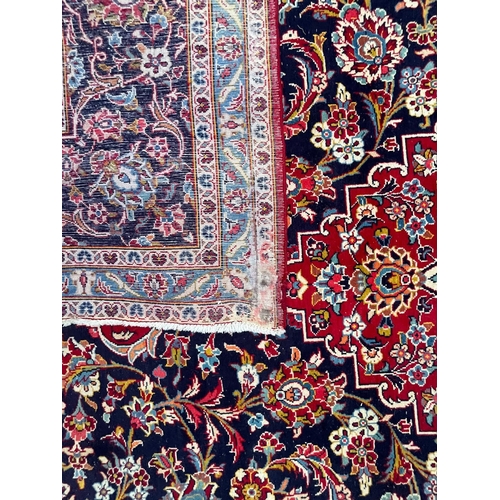 203 - A large 20th century Persian Islamic Tabriz floor carpet rug. The carpet having a central medallion ... 