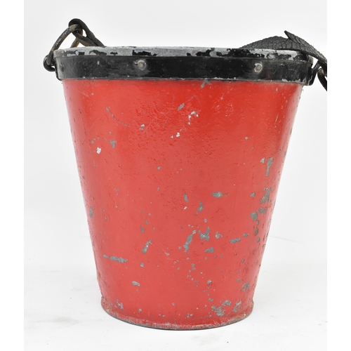 206 - An early 20th century black & red painted metal fire bucket. The bucket with leather adjustable hand... 