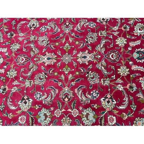 209 - A large 20th century Persian Islamic Tabriz floor carpet rug. The carpet having a central panel on r... 