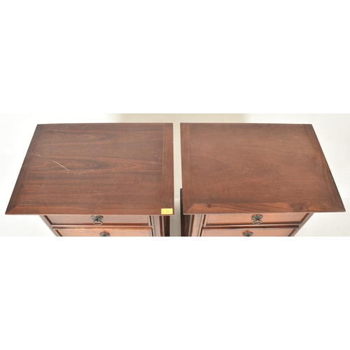 211 - A pair of contemporary hardwood bedside chest of drawers / cabinets. Each having a rectangular flare... 