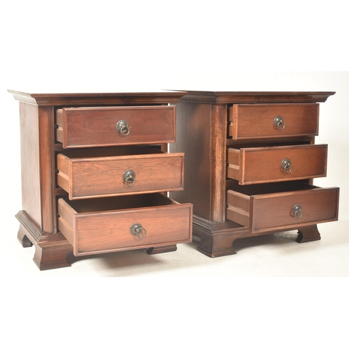 211 - A pair of contemporary hardwood bedside chest of drawers / cabinets. Each having a rectangular flare... 