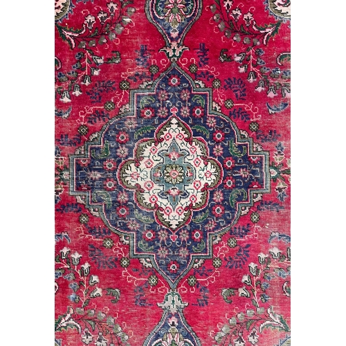 213 - A 20th century Persian Islamic Tabriz floor carpet rug. The carpet having a cream & blue ground ... 