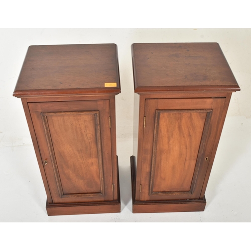 216 - A pair of early 20th century Edwardian mahogany pedestal bedside cabinets / cupboards. Each having a... 