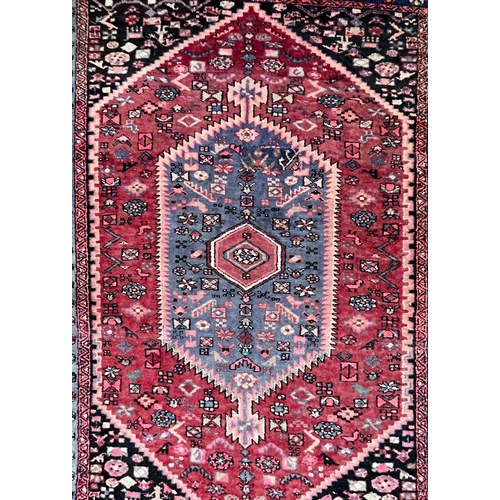 219 - A 20th century Persian Islamic Tabriz floor carpet rug. The carpet having a series of repeating geom... 