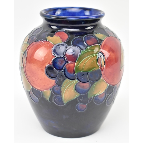 227 - William Moorcroft - Pomegranate pattern - an early to mid 20th century ceramic vase. The vase of bul... 