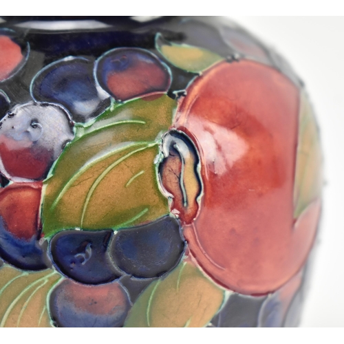 227 - William Moorcroft - Pomegranate pattern - an early to mid 20th century ceramic vase. The vase of bul... 