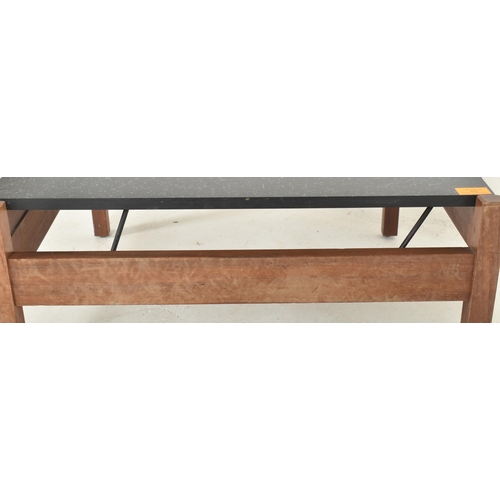 237 - Guy Rogers - a 1960s teak framed coffee table / low table. The table having a metamorphic black lami... 