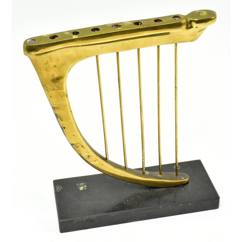 238 - A 20th century brass & slate Hannukah Menorah candle holder in the shape of an harp. The candleh... 