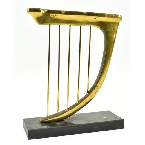 238 - A 20th century brass & slate Hannukah Menorah candle holder in the shape of an harp. The candleh... 