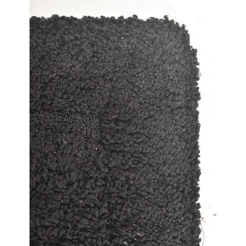 254 - Auckland - a contemporary designer thick pile black carpet rug. The rug of rectangular form with sha... 