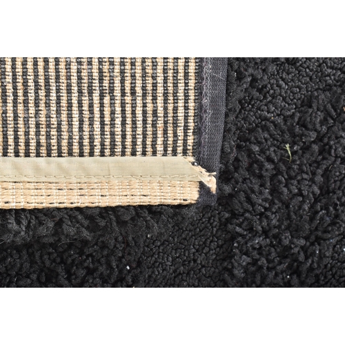 254 - Auckland - a contemporary designer thick pile black carpet rug. The rug of rectangular form with sha... 