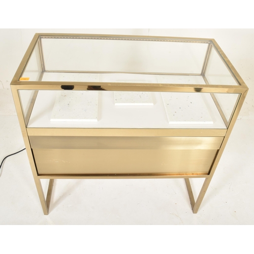 269 - A contemporary high end design gilt metal & glass bijouterie display cabinet table. The cabinet ... 