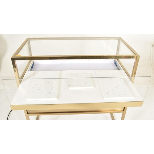 269 - A contemporary high end design gilt metal & glass bijouterie display cabinet table. The cabinet ... 