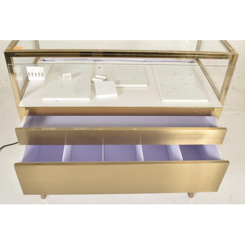 269 - A contemporary high end design gilt metal & glass bijouterie display cabinet table. The cabinet ... 